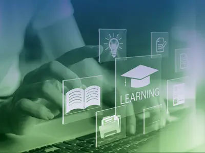 Hands on computer keyboard with icons of online learning 