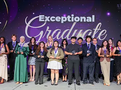 Exceptional Graduates group on stage with awards