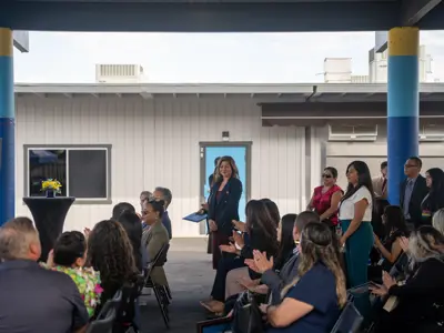Members of audience standing and audience applauding