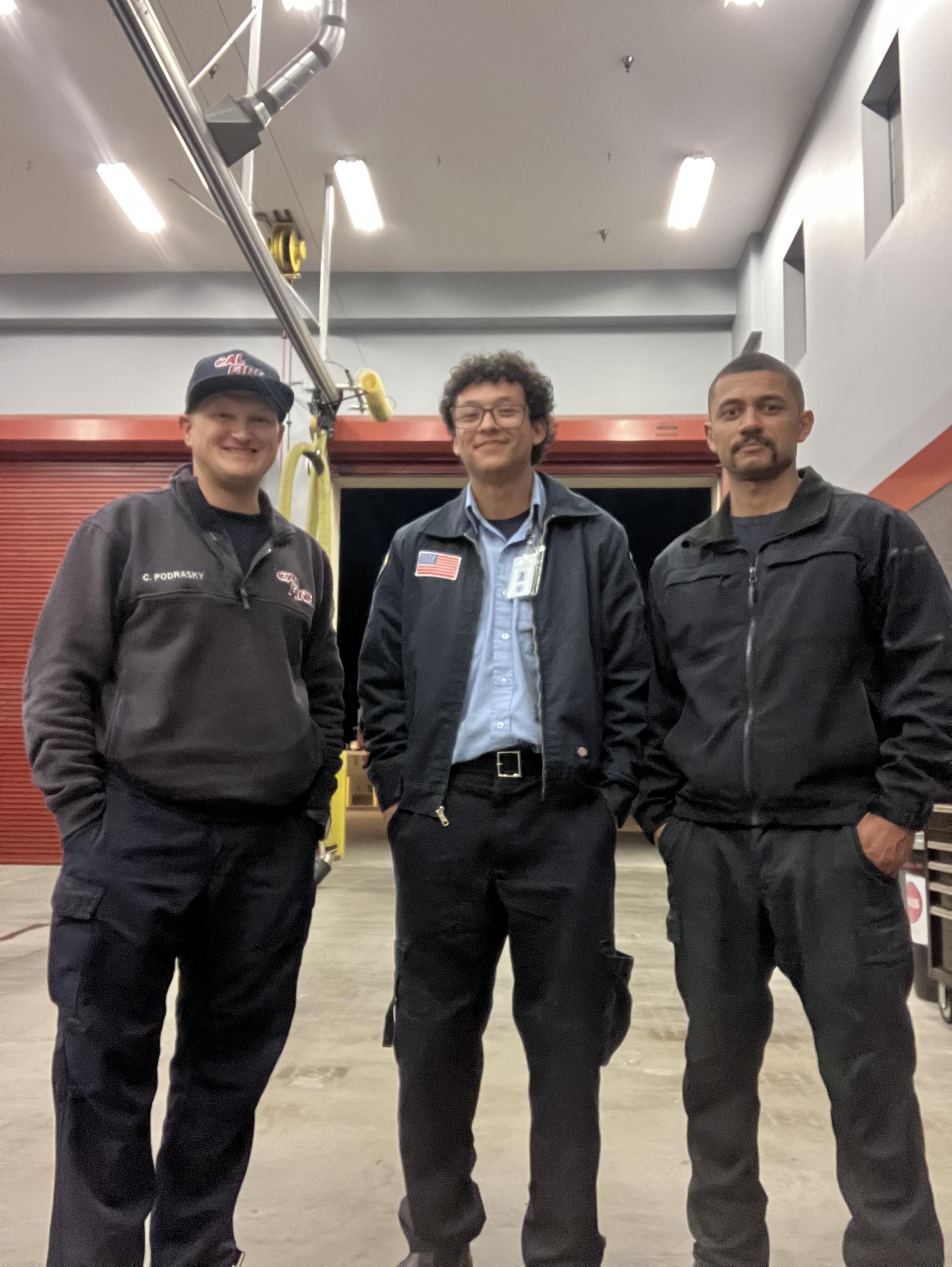 Simon Garcia in the middle of two EMT supervisors.