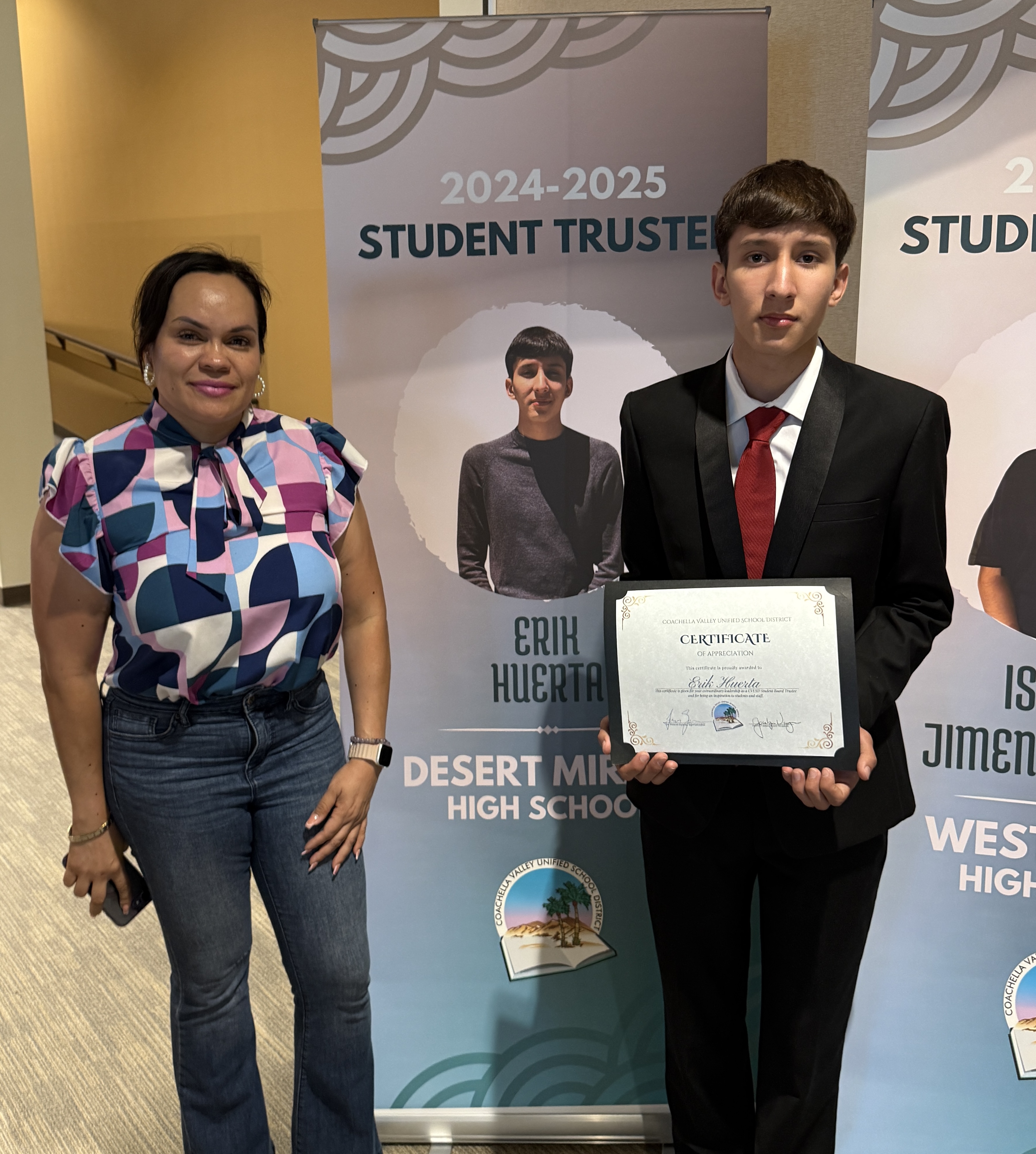 Erik infront of his Student Tustee banner