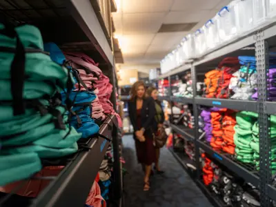 Visitors viewing shelfs full of colorful backpacks