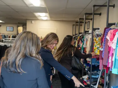 visitors pointing at items in clothing store