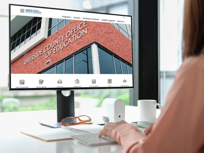 Person viewing RCOE website on computer 