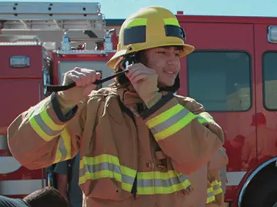 Student adjusting strap on fire helmet
