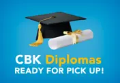 Graduation cap and diploma rolled with yellow ribbon