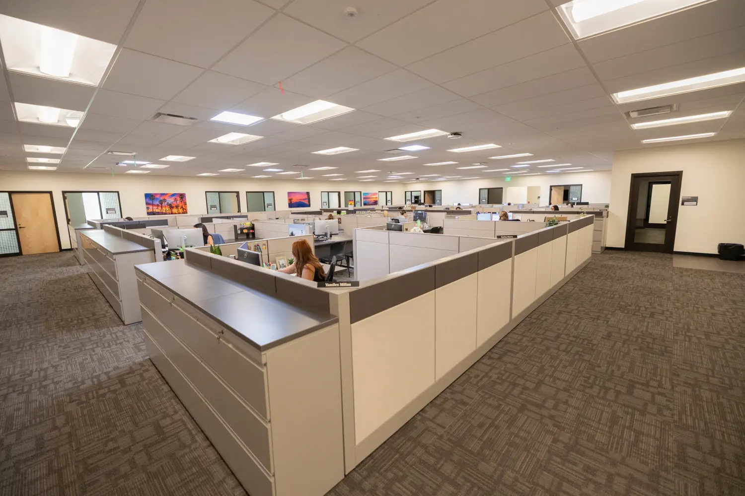 New office space with multiple cubicles surrounded by offices